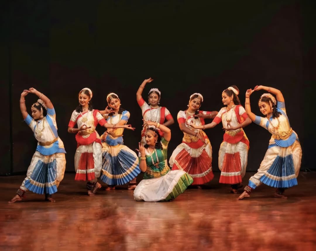 Bharatanatyam dancers performing a group piece on stage – Vaidic Sanskriti Kala Kendra